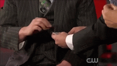 Close-up of Kostya Kimlat’s hands running through a deck as red and black cards separate